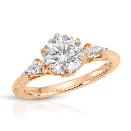 rose gold round moissanite ring with kite cut moissanite side stone