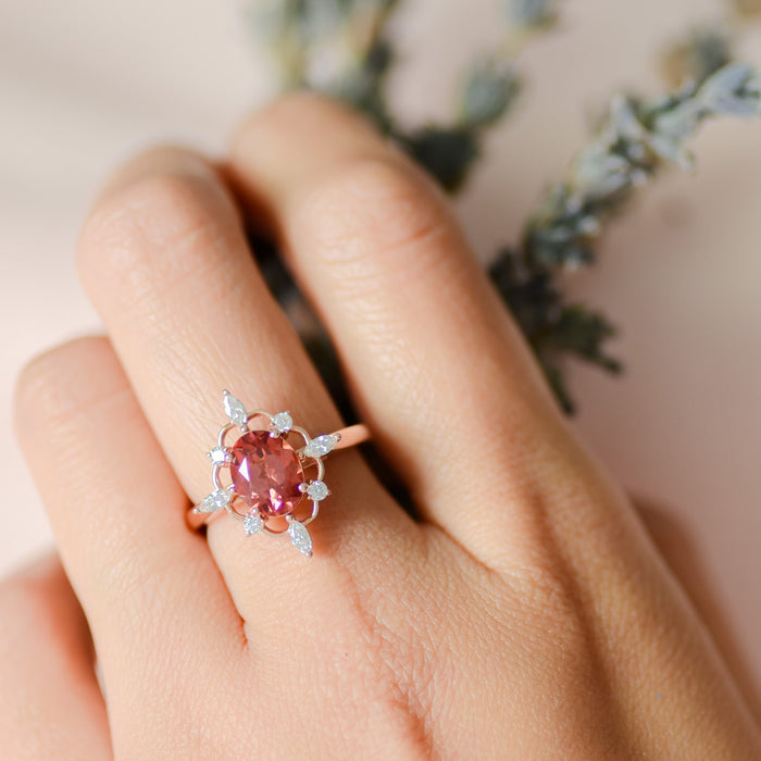 Padparadscha pink sapphire moissanite ring on finger